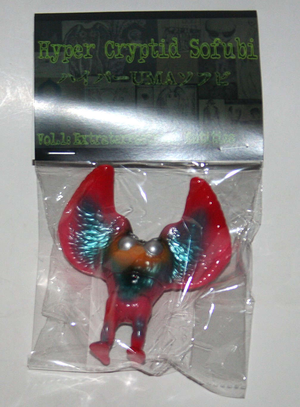 Studio Kabuto Hawaiian Mothman cryptid sofubi in pink vinyl with blue, black and yellow paint